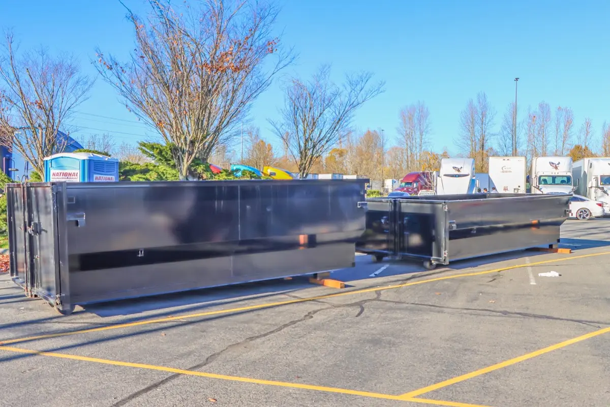 Professional dumpster rental service with roll-off container on residential driveway in Chisago City